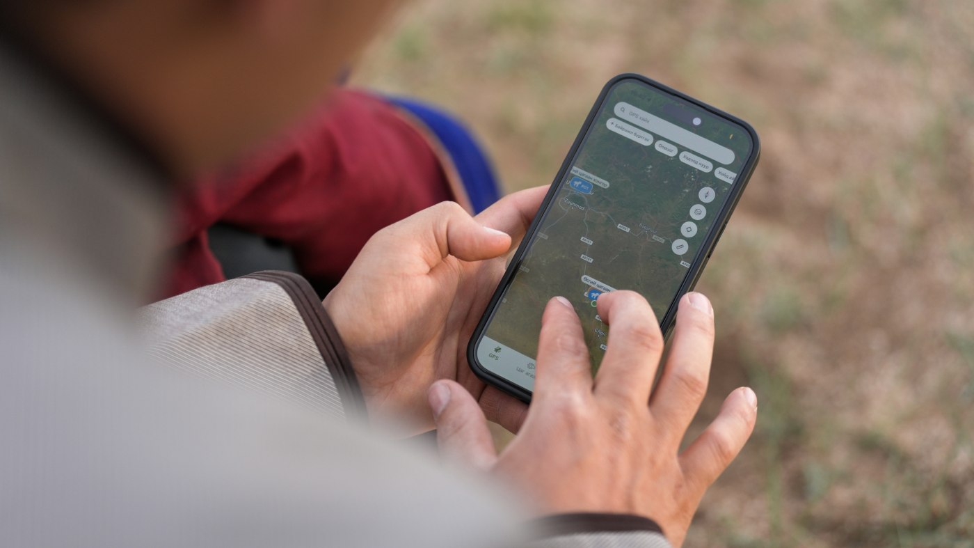 A herder checking the Hunu app on his phone